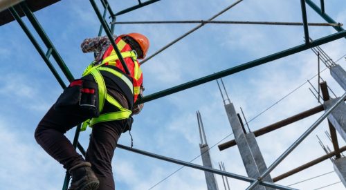 Working at heights of workers in safety clothing at the construction site
